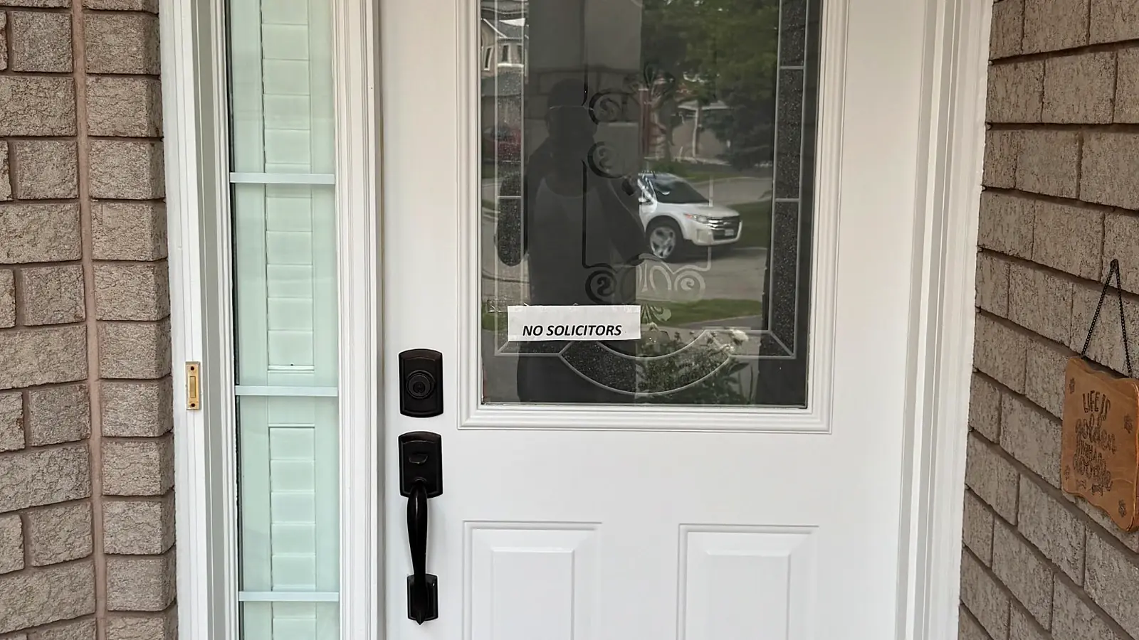 Real finished white exterior entry door and surrounding trim