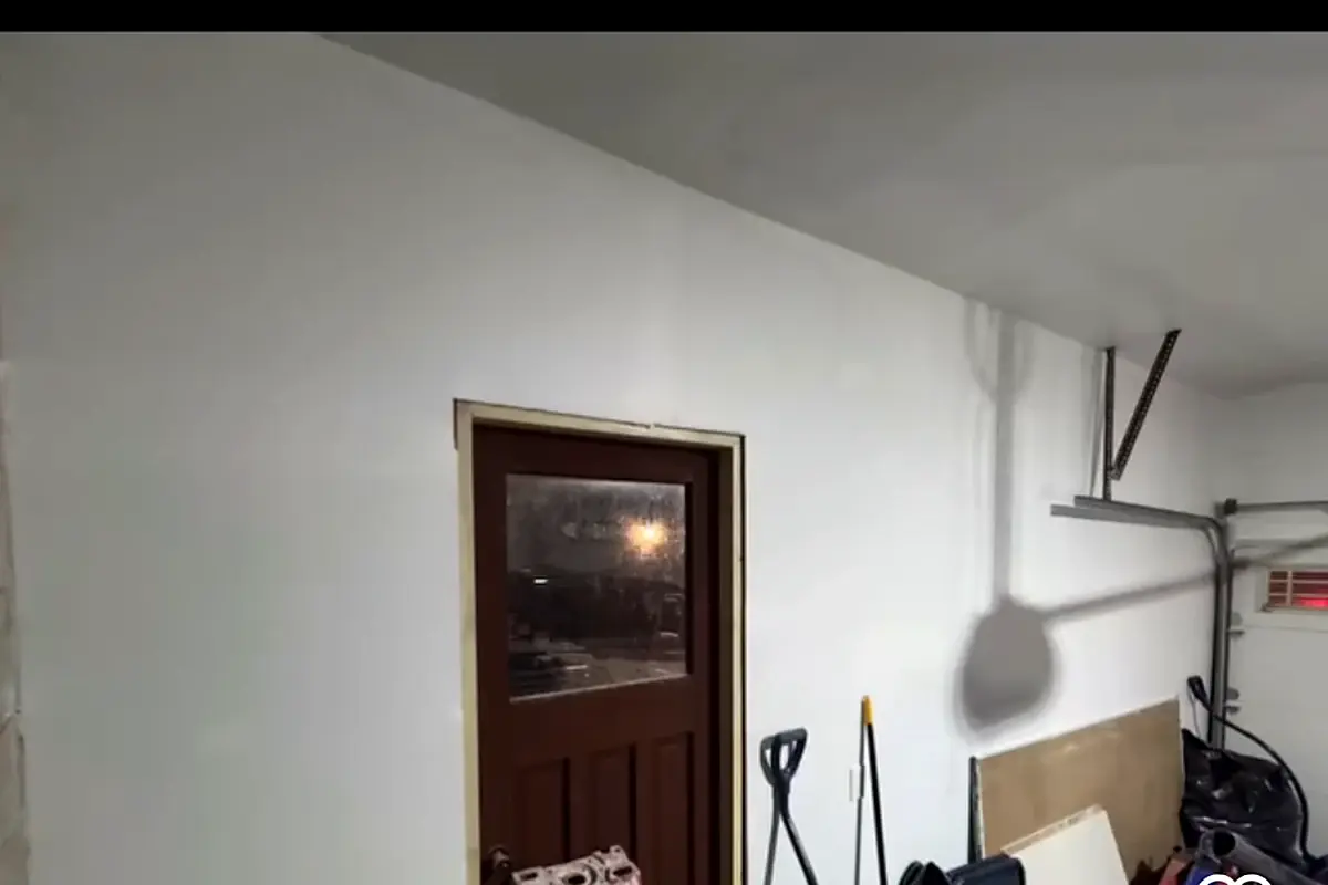 Real completed garage with finished drywall walls and ceiling